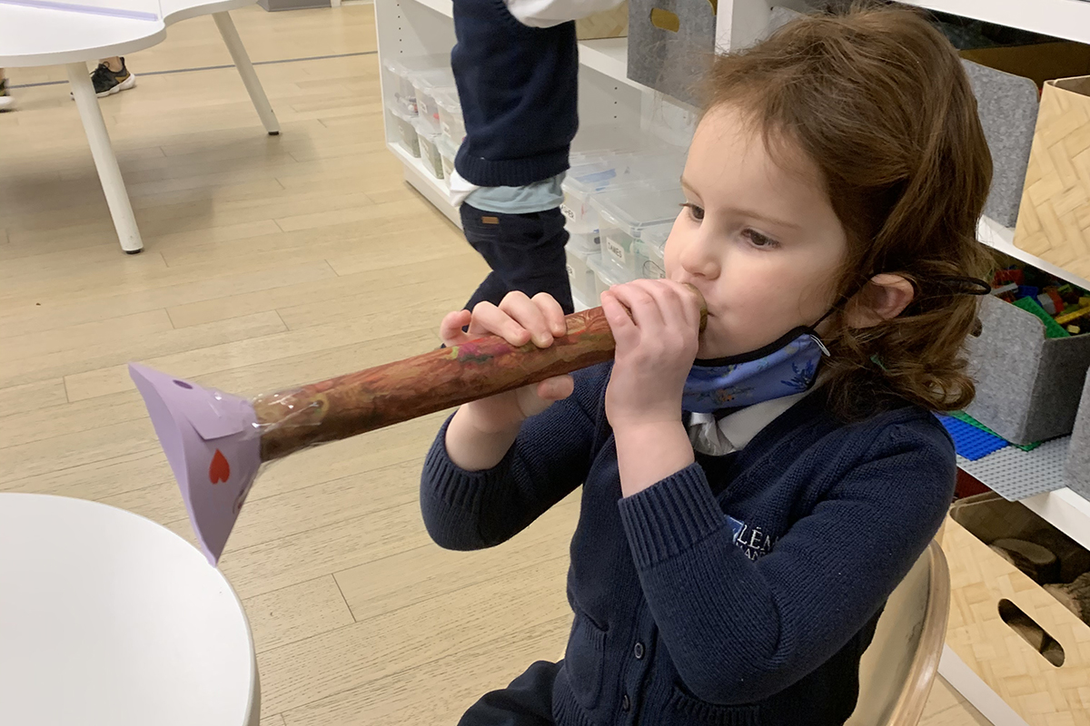 Child plays a homemade instrument 