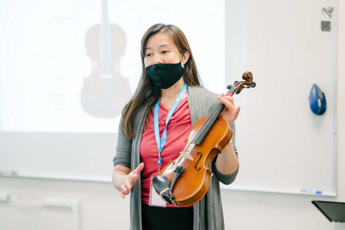 Teacher holding a violin